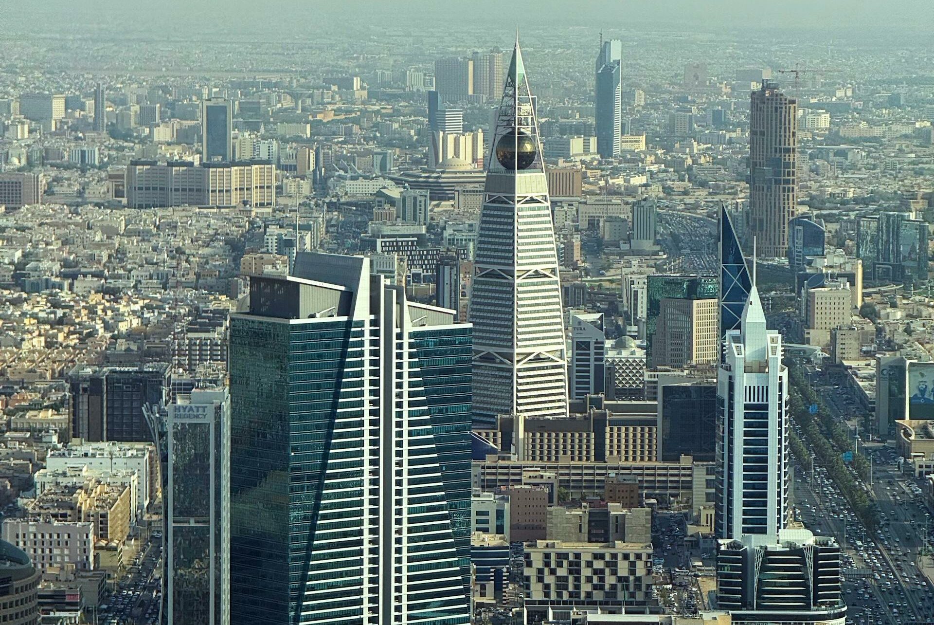 Aerial view of Riyadh's skyline featuring modern skyscrapers on a clear day.