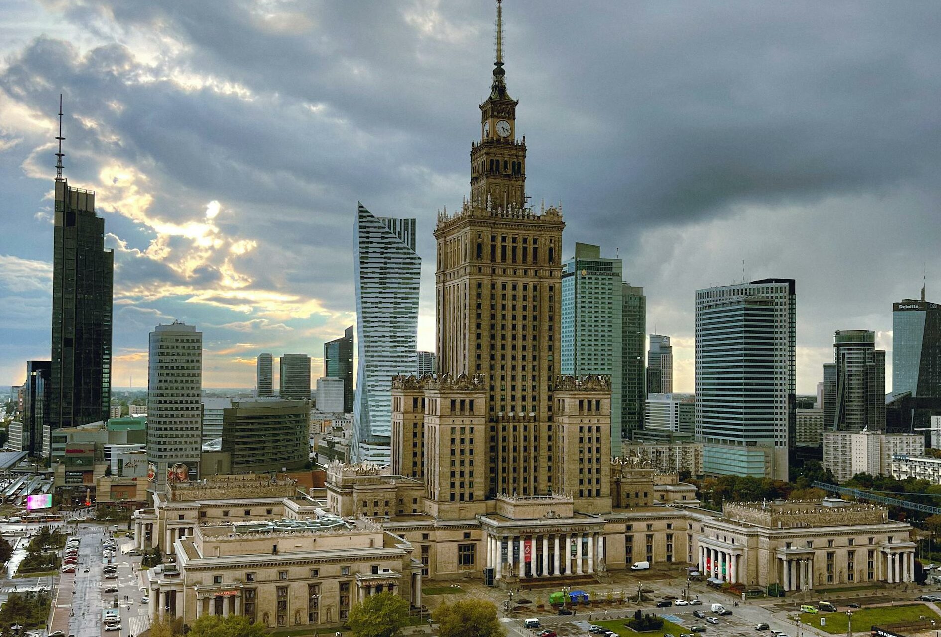 Aerial view of the Palace of Culture and Science surrounded by modern skyscrapers in Warsaw.