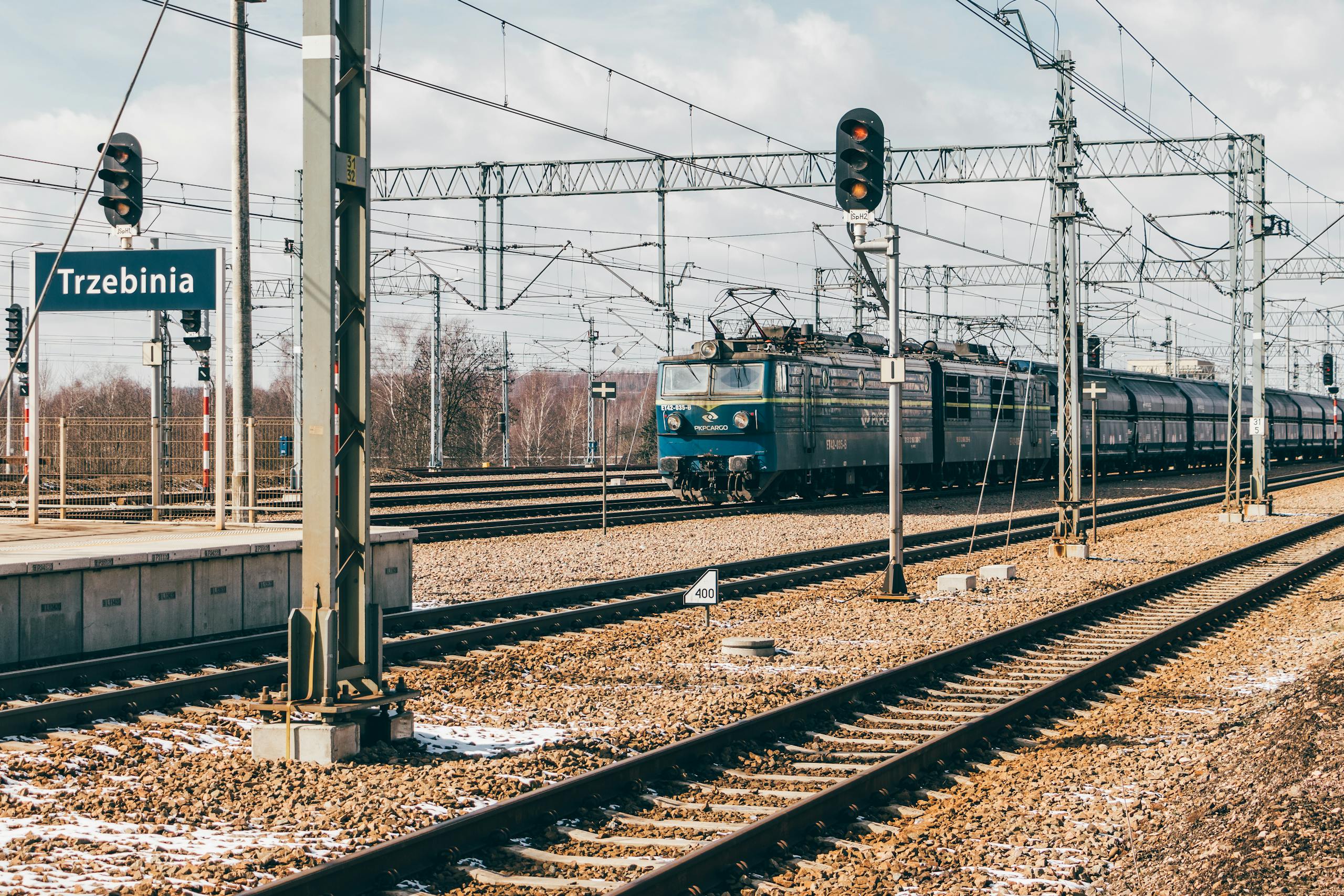 Cargo train at Trzebinia railway station in Poland, showcasing transport infrastructure.